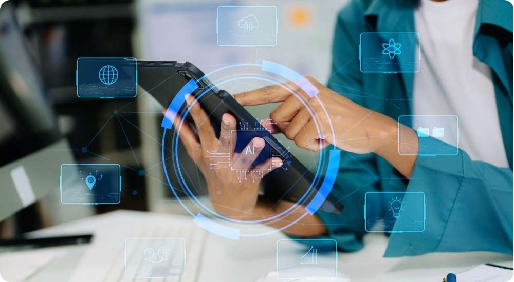 A person's hands using a tablet with a futuristic, data-oriented interface overlaid with icons like a globe, atom, and lightbulb, suggesting technology, data analysis, or AI.