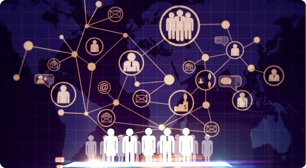 A graphic showing a world map with a digital network overlay of interconnected nodes representing people, groups, email, and business. A row of figures stands at the bottom, symbolizing global business connectivity and talent networking.
