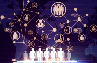 A graphic showing a world map with a digital network overlay of interconnected nodes representing people, groups, email, and business. A row of figures stands at the bottom, symbolizing global business connectivity and talent networking.