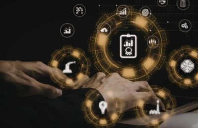 A person's hands interact with a futuristic digital interface displaying a network of interconnected icons for business functions, including human resources, automation, and data analysis, symbolizing the strategic management of a complex and large-scale workforce using technology.