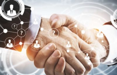 A close-up shot of two business people shaking hands, with a digital network graphic and icons of people and question marks overlaid, symbolizing future recruitment partnerships and technological collaboration.