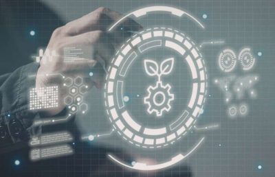 A person's hand interacting with a futuristic holographic interface displaying a digital icon of a gear combined with a growing sprout, symbolizing a mature technology organization, growth, and sustainable strategy.