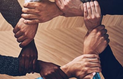 Solidarity, holding or hands of business people with diversity for group support or teamwork in office. Community, link or above group of employees with mission or team building for startup goals together